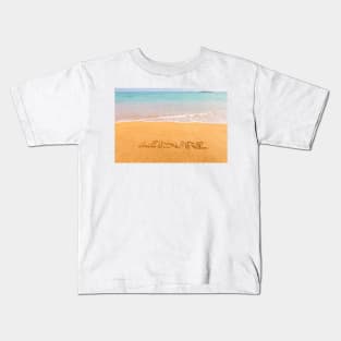 Inscription "LEISURE" made on beautiful beach by the blue sea Kids T-Shirt